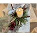 Unfinished logs are cut and ready to be made into a rustic Christmas decoration. Faux greenery and berries fill a vintage nail bucket. 