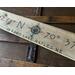 A personalized lake home sign with a compass. This shows the location of Sebago Lake in Maine. It is handmade with distressed wood. 