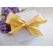 White jewelry gift box with a satin champagne ribbon.