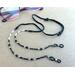 Adjustable Black and White Eyeglass Chain made with soft suede cord. Converts to a 4-strand wrapped bracelet.