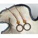Earrings featuring copper circles and topaz colored crystal bicone beads on copper chain and handcrafted earring wires.