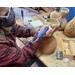 This shows me carving the dried gourd. I am adding a decorative wavy edge with a stipled texture to the top of the gourd. 