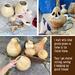 This shows several unfinished gourds, one gourd with it's face being carved, also the dried seeds that are removed from the  the gourds. 