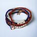 Red, white and blue stretchy stacking bracelets.