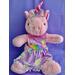 Measurements: 15" head to feet - 14.5" diameter. Unicorn is pink with shades of pink taffeta for horn on her head and for her ears.  She is wearing a pinafore made by Flute Emporium and has a blue metal basket with Easter Eggs situated next to her.  A cute collectible for a flutist or with a flute.