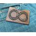 handmade wallet featuring the Ouroboros symbol in warm brown with ivory stitching