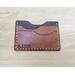 handmade wallet featuring the Ouroboros symbol in warm brown with ivory stitching
