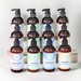 Twelve bottles of luxurious aromatherapy lotions by Whole Self Aromatherapy atop a white table with blocks of wood as a tiered display.