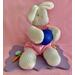 Measurements: Bunny 9" tall  x 4" wide - Plaque 7.5" length x 5" wide. Lilac decorative base with Easter eggs and holding a large royal blue egg.  He is wearing a pink rompler ourt in velour fabric.  Cute collectible or fun centerpiece for the holiday table.