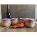 Four purple hand-thrown ceramic wine tumblers, each tumbler holds 12 ounces.
