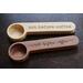 Beech and sapele wooden coffee scoops, laser engraved with the saying "not before coffee".