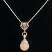 Beautiful Rose Quartz stone is viewed on a flute trill key.  A fleur de lis bail on a  16" silver plated snake chain.