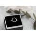 Sterling silver ring with an open circle top.