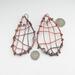 woven copper wire large dangle earrings with 6mm turquoise and copper composite gemstone cabochon, photo shows earrings, shown with dime and quarter for size comparison