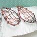 woven copper wire large dangle earrings with 6mm turquoise and copper composite gemstone cabochon, photo shows earrings