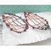 woven copper wire large dangle earrings with 6mm turquoise and copper composite gemstone cabochon, photo shows earrings