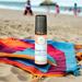 Beach Vibes roll-on wellness blend by Whole Self Aromatherapy on a colorful blanket at the beach, with children playing in the background.
