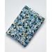 A padded book sleeve made with a blue floral Rifle Paper Co. cotton print called Garden Party Blue.