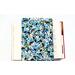 A padded book sleeve on top of an open book. The book sleeve is made with a blue floral Rifle Paper Co. cotton print.