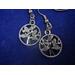 round dangle earrings with a rhinestone encrusted leaf pattern.