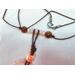 Rose quartz beads on a brown leather cord.