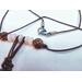 Brown leather cord with rose quartz beads and a stainless steel lobster clasp.