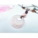 Ceramic Bead atop a rose quartz gogo pendant on a brown leather cord.