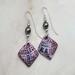 Purple and silver square dangles embossed with geometric shaped imprints hung with silver swarovski pearls. Handcrafted silver earring wires