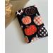 this pumpkin kindle sleeve has a black background with pumpkins having different prints on them