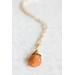 Sunstone necklace, orange briolette in 14K gold, on white background. 