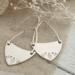 Handcrafted sterling silver fern-stamped hoop earrings on burlap with white flowers, made in Soldotna, Alaska. 

