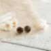 Smokey Quartz and sterling silver earrings on linen fabric with dried flowers and white wood background. 