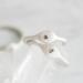  Two sterling silver stackable rings with lowercase initials "a," a heart,  on a white  background 