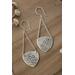 Sterling silver trillion shape imprinted with a mandala design hanging from sterling silver chain from two corners and a sterling ear wire. 