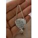 Sterling silver trillion shape imprinted with a mandala design hanging from sterling silver chain from two corners and a sterling ear wire. 