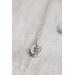 small silver charm made from a recycled silver ball hammered flat and stamped with a fern design on a sterling silver chain.