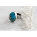 Sterling silver ring featuring chunky turquoise free form stone with silvery pyrite inclusions and a floral textured band.