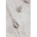 small silver charm made from a recycled silver ball hammered flat and stamped with a fern design on a sterling silver chain.