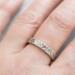  Close-up of a sterling silver floral textured ring on a finger, showcasing its 4mm floral design
