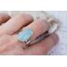 Sterling silver ring band featuring a oblong sea green/blue Chalcedony stone in a sterling silver bezel.