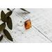 Square Baltic amber cabochon set on a textured organic band and bezel.