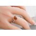 Pear shaped Baltic amber cabochon set on a textured organic band and bezel.