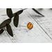 Pear shaped Baltic amber cabochon set on a textured organic band and bezel.