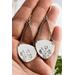 Trillion shaped sterling silver earrings stamped with a floral design hanging from sterling silver chain a French hook ear wire. 