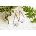 Trillion shaped sterling silver earrings stamped with a floral design hanging from sterling silver chain a French hook ear wire. 