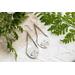 Trillion shaped sterling silver earrings stamped with a floral design hanging from sterling silver chain a French hook ear wire. 