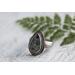 Pear shaped clear agate stone with flecks of greens blues copper in a sterling silver bezel surrounded by beaded wire on floral comfort band