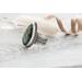 Silver ring with pear-shaped faceted labradorite featuring blue-green opalescent flashes serrated bezel and bead detailing around the bezel.