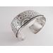 Wide sterling silver bracelet with mandala textured overlay.