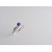 Denim lapis ring with beaded silver band on a wooden surface, showcasing eco-friendly craftsmanship.
